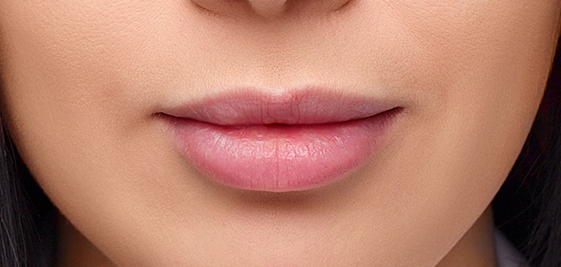 Etwas auf den Pinsel auftragen oder   Wattestäbchen   und maskieren Sie den Überschuss, um die Kontur der Lippen perfekt glatt zu machen